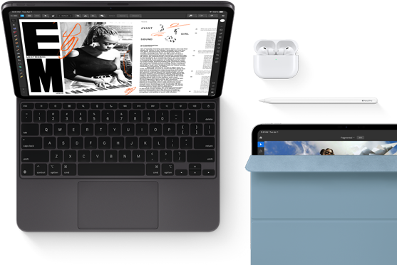 iPad Pro attached to Magic Keyboard, front exterior, space black color, rounded corners, black display bezel, open, display showing article editing app with text and photograph of a woman playing music, Airpods 4 in open case, blue Smart Folio cover on iPad Pro with Apple Pencil Pro resting atop device, cover slightly open revealing display